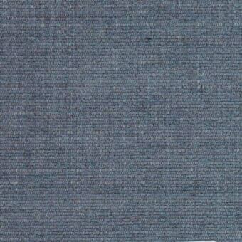 Heathered fabric texture in muted blue-gray with brown and beige threads, dense weave, matte finish, labeled “Ditre Italia Manhattan 104”.